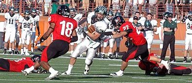 Clay Finn (22) tries to bring down Cedar Park's Alex Curl as Omar Duke-Tinson (18) charges in. DSC_0143.jpg