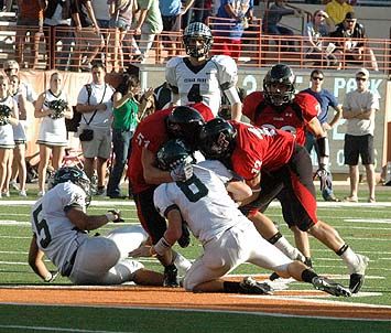 Austin Williams (51) and Zach Streuling wrap up Alex Curl. DSC_0158.jpg