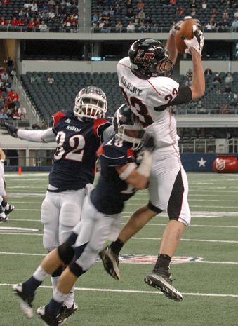 Griffin Gilbert reaches above two defenders for a leaping catch. gilbert.jpg
