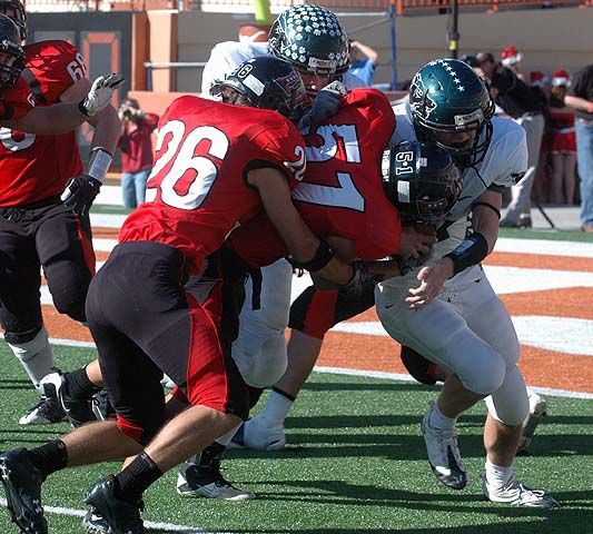 Austin Williams (51) and Dane Balasz (26) team up to bring down a Cedar Park runner. dsc_0056.jpg