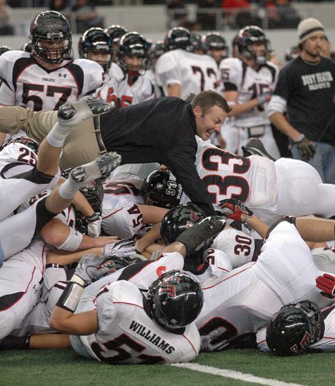 Cavalier players and coaches begin to celebrate the title. dogpile.jpg