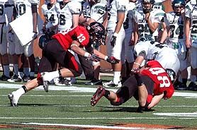 Zach Streuling (13) and Jacob Garner (48) bring down a Cedar Park runner. dsc_0025.jpg