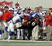 Zach Austin tries to pull in a pass while being hit by a Midway defender. austin lunge.jpg