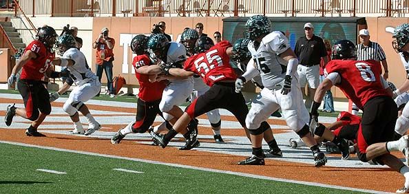 Johnathan Roberts and Jude Jeffress (55) try to keep a Cedar Park running back pinned deep in his own territory. DSC_0051.jpg