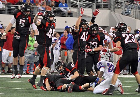 Lake Travis defenders celebrate a key fumble recovery. fumble rec.jpg