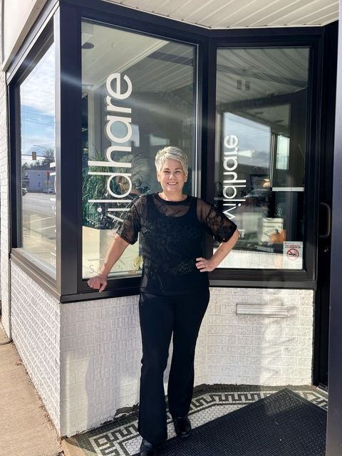 Carrie, owner of Wild Hare Salon, standing proudly in front of the salon to celebrate 25 years of transforming hair & hearts in Marengo, Illinois. Carrie from Wild Hare Salon Celebrating 25 Years in Marengo, IL