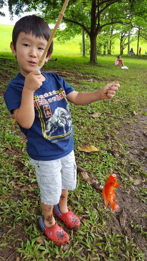 Marc's son, Zane Inouye (3), skillfully catches his first Red Devil. Zane Fishing 2.jpg