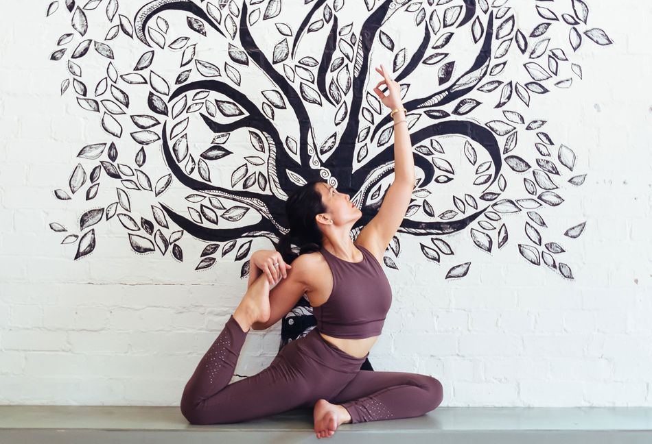 Image of a lady doing a yoga stretch in front of a tree painting on the wall Body-Ethos-Open-Day-2020-Kylie-Morello-4505-2.jpg