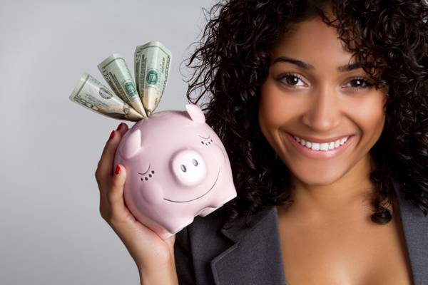 Woman holding a piggy bank discounts