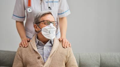 doctor-and-senior-man-wearing-facemasks-WHEYLVG.jpg