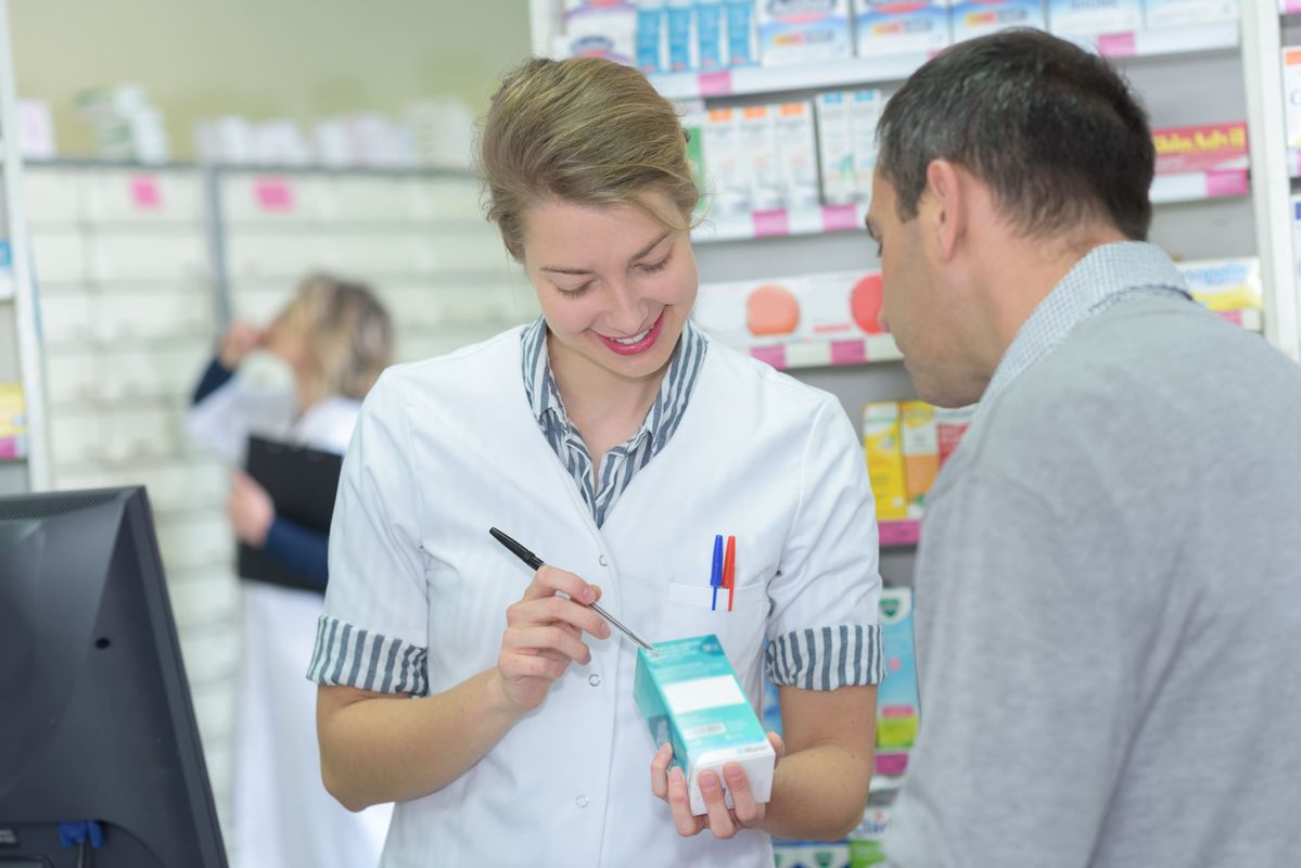 a pharmacist speaks to a patient