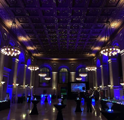 Holiday party in library with blue lighting and cocktail tables