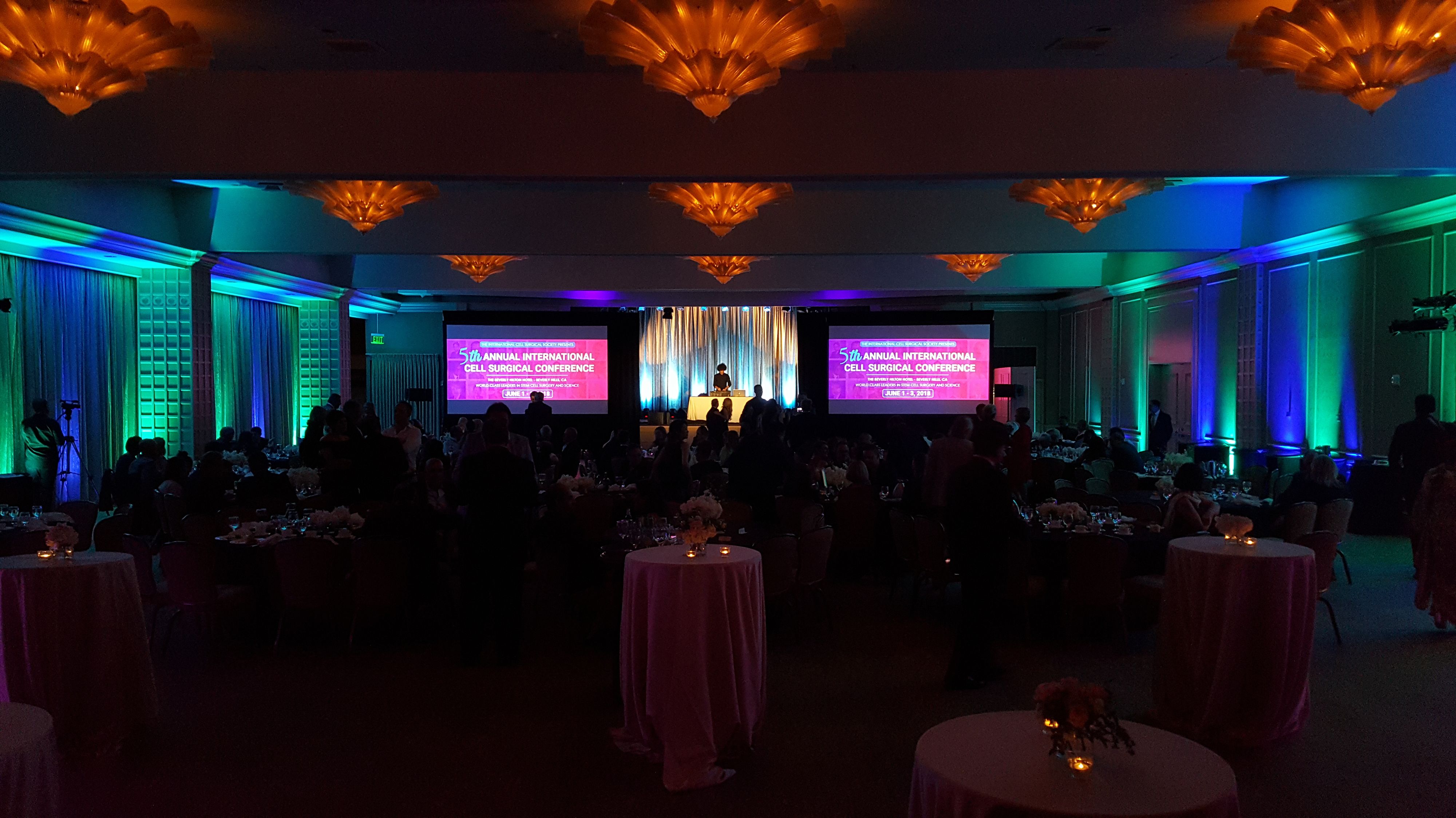 Gala in ballroom with blue and green lighting 