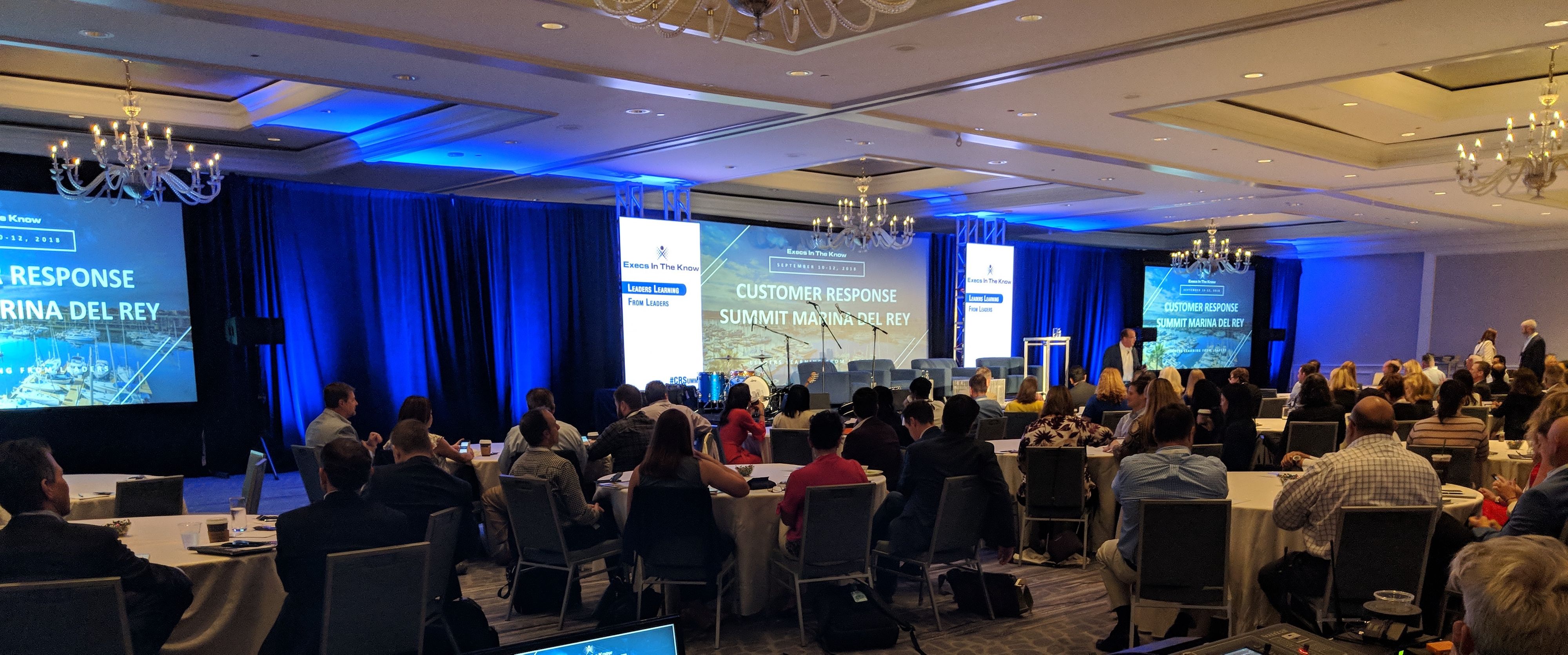 Three Projection Screen Conference Layout with Blue Lighting in a hotel ballroom