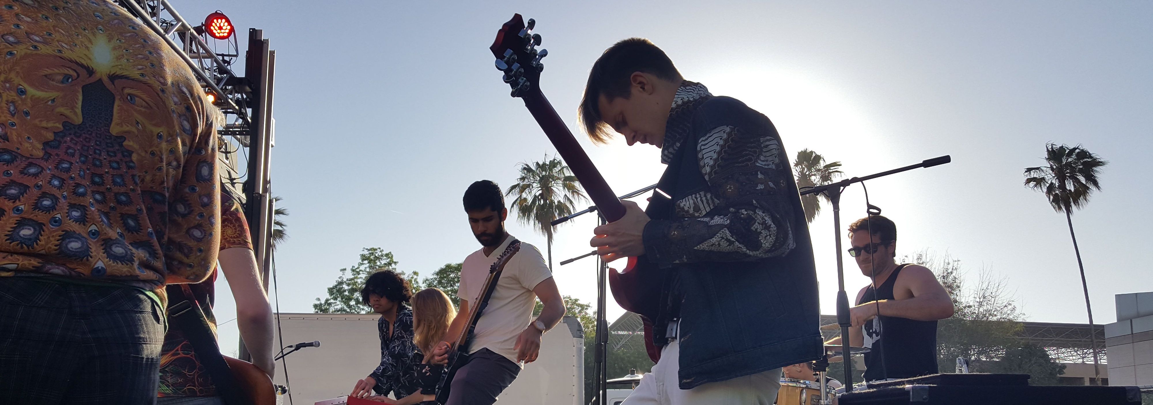 Man playing electric guitar at an outdoor concert in Austin, Texas