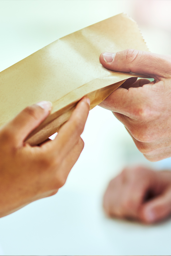 Pharmacist handing over prescription Homepage