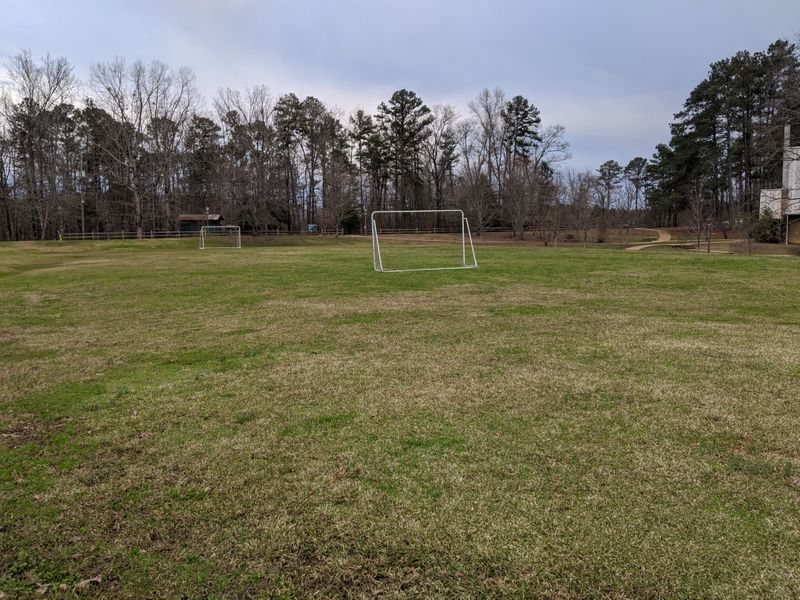 The soccer field is located on Delong Road, between the Chapel of St. Francis and Stough Lodge and in front of the Scott House. There is a grilling pavilion at the back near Stough Lodge and a playground in front of the Scott House. soccer field.jpg