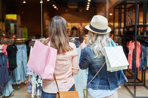 Two women shopping holding bags