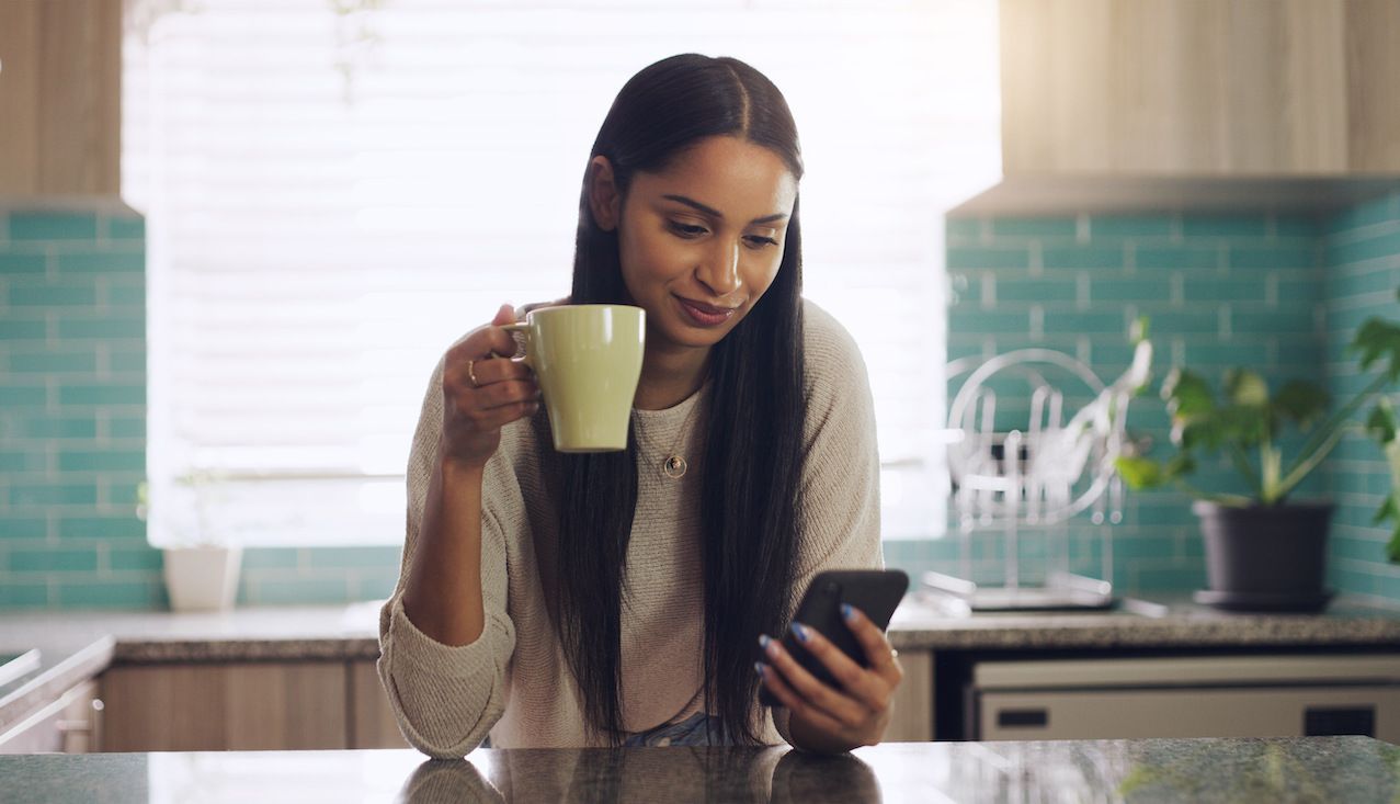 shot-of-a-young-woman-drinking-coffee-while-using-2022-10-07-20-31-38-utc.jpg