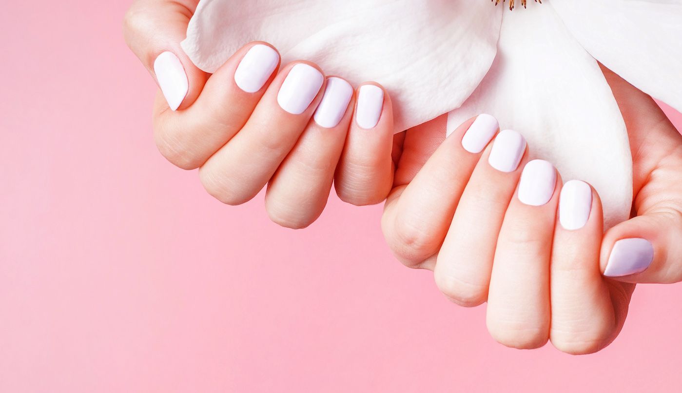 female-hands-with-white-manicure-holds-magnolia-fl-2023-06-01-21-51-22-utc.jpg