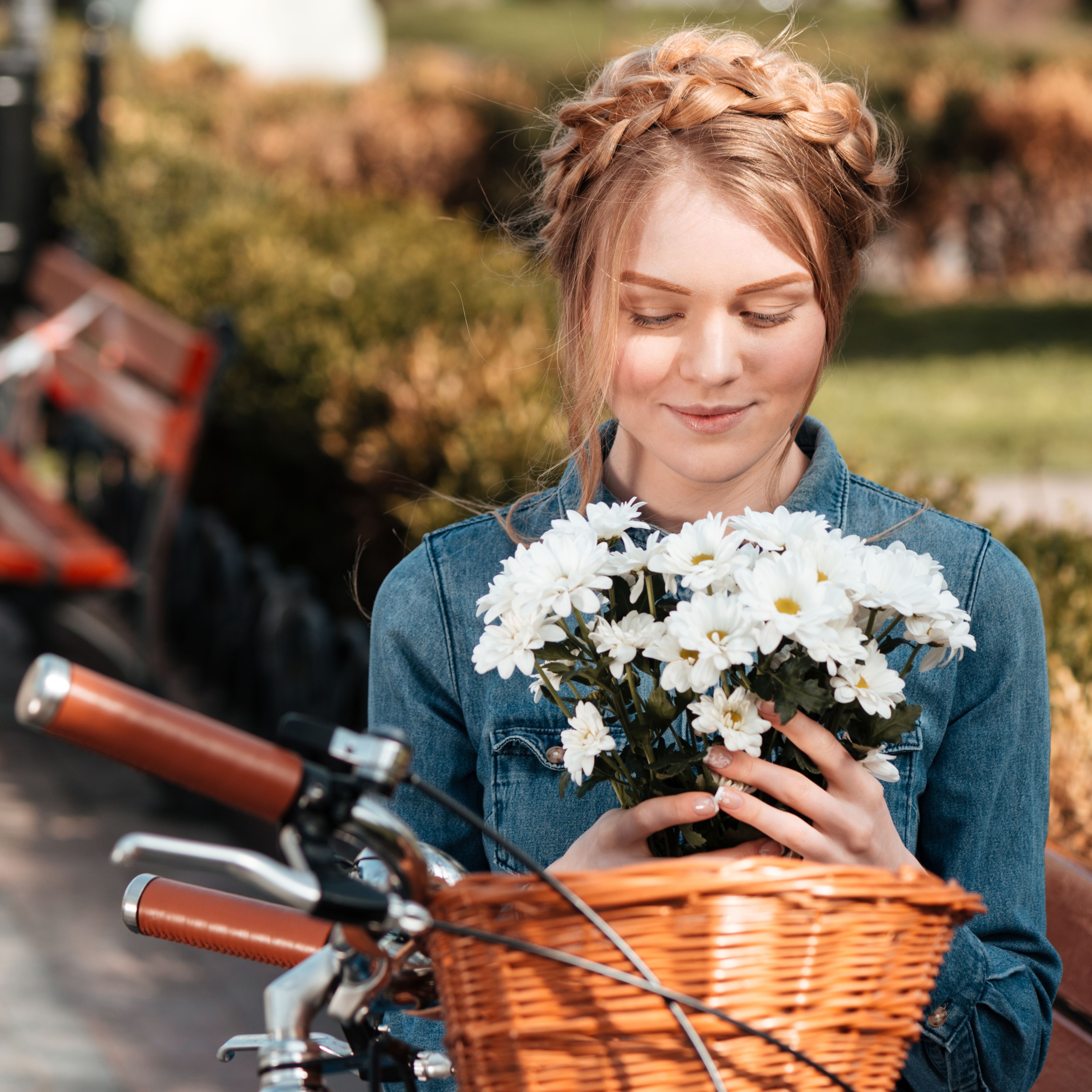 charming-woman-with-bicycle-holding-bouquet-of-flo-PFBTXD3.jpg