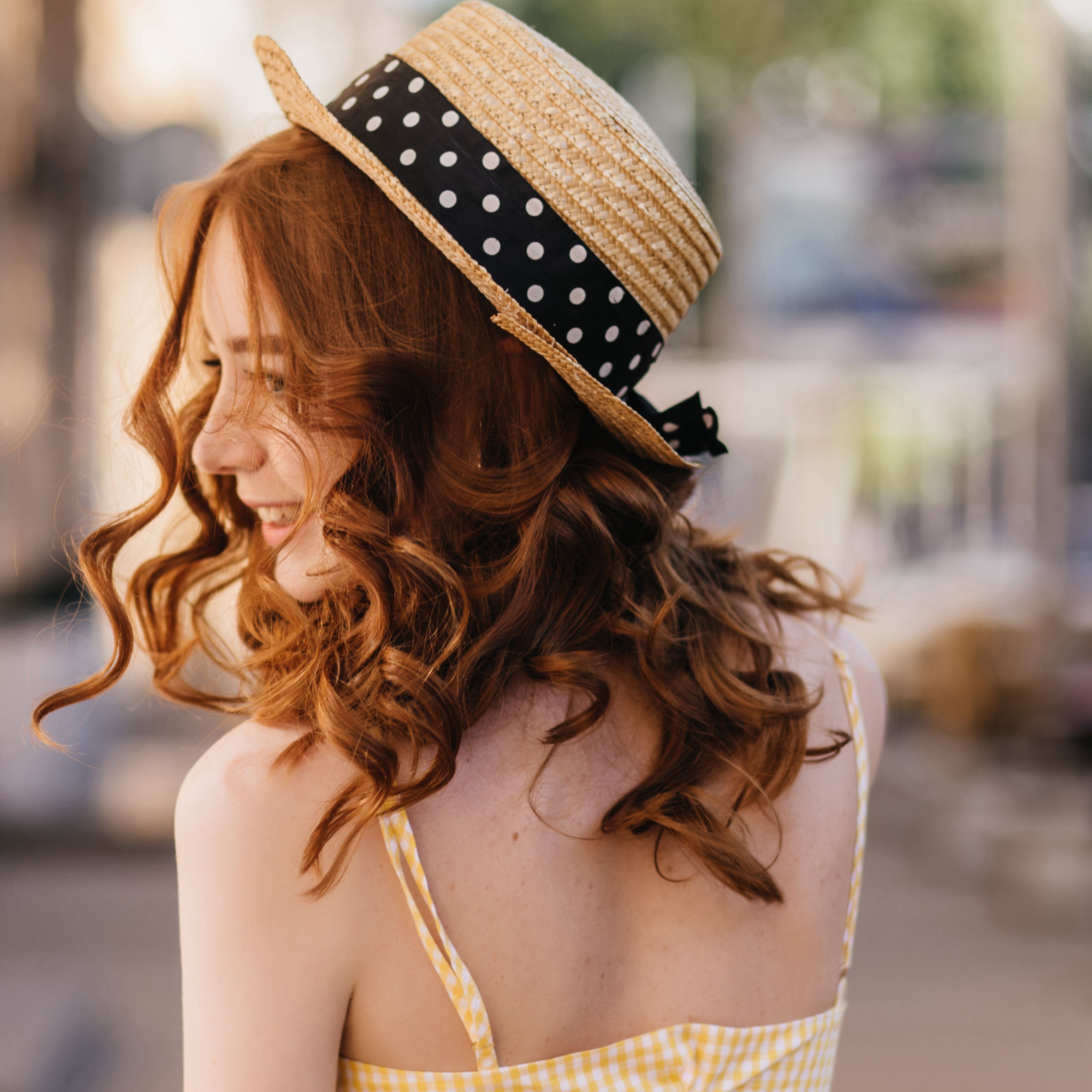 portrait-from-back-of-carefree-ginger-woman-in-hat-XBRKRYV.jpg