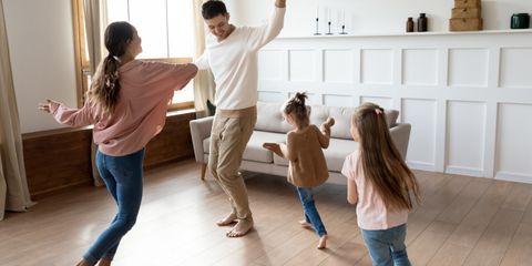 family-of-four-dancing-in-living-room.jpeg