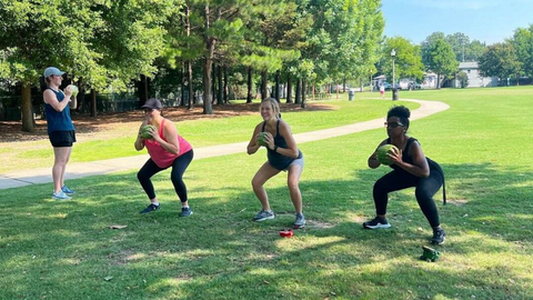 fit for mom birmingham photo of moms exercising with watermelons in the park.png