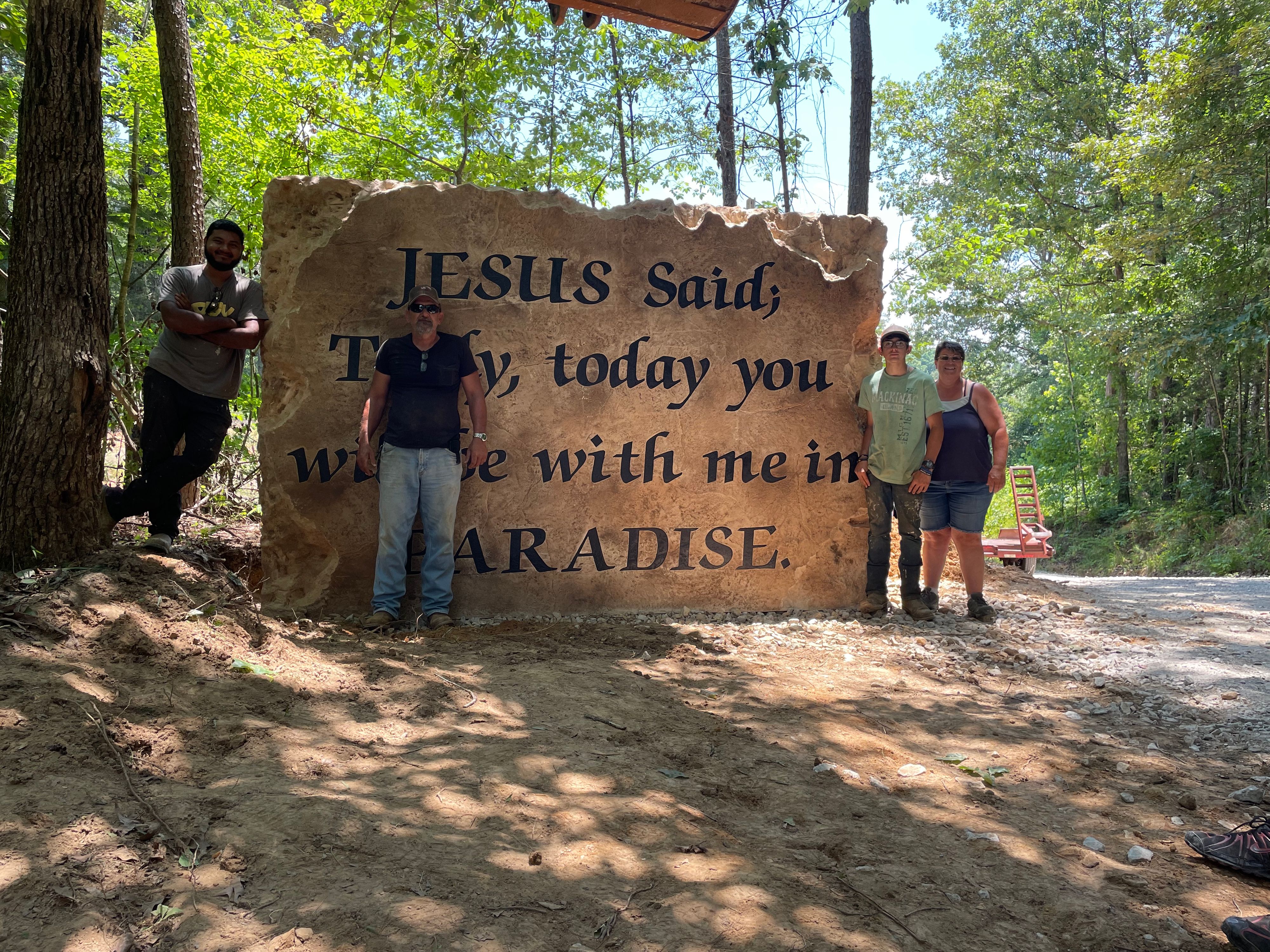 Jesus stone with people in front of it.jpeg