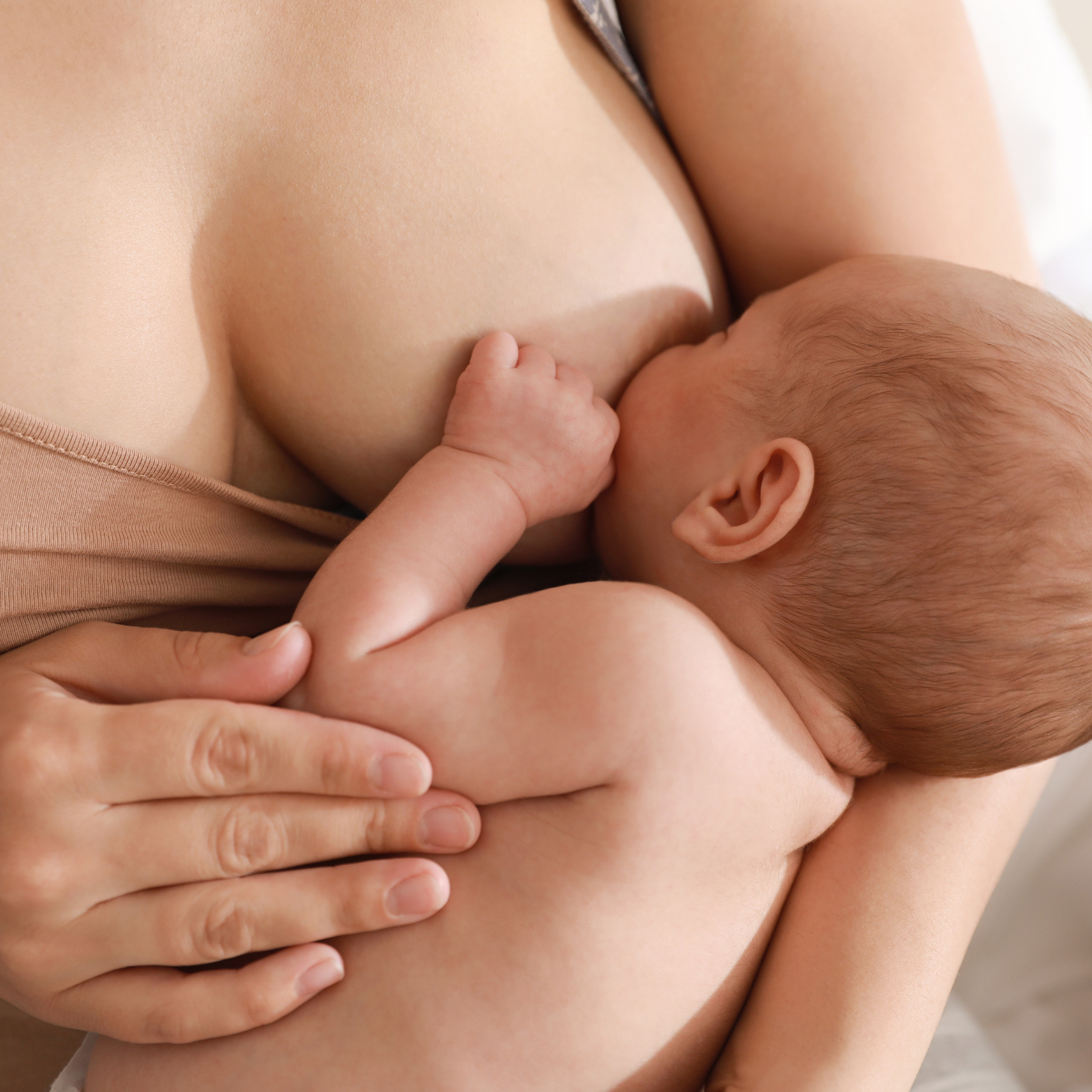 Breastfeeding mother finding relief with nipple cream
