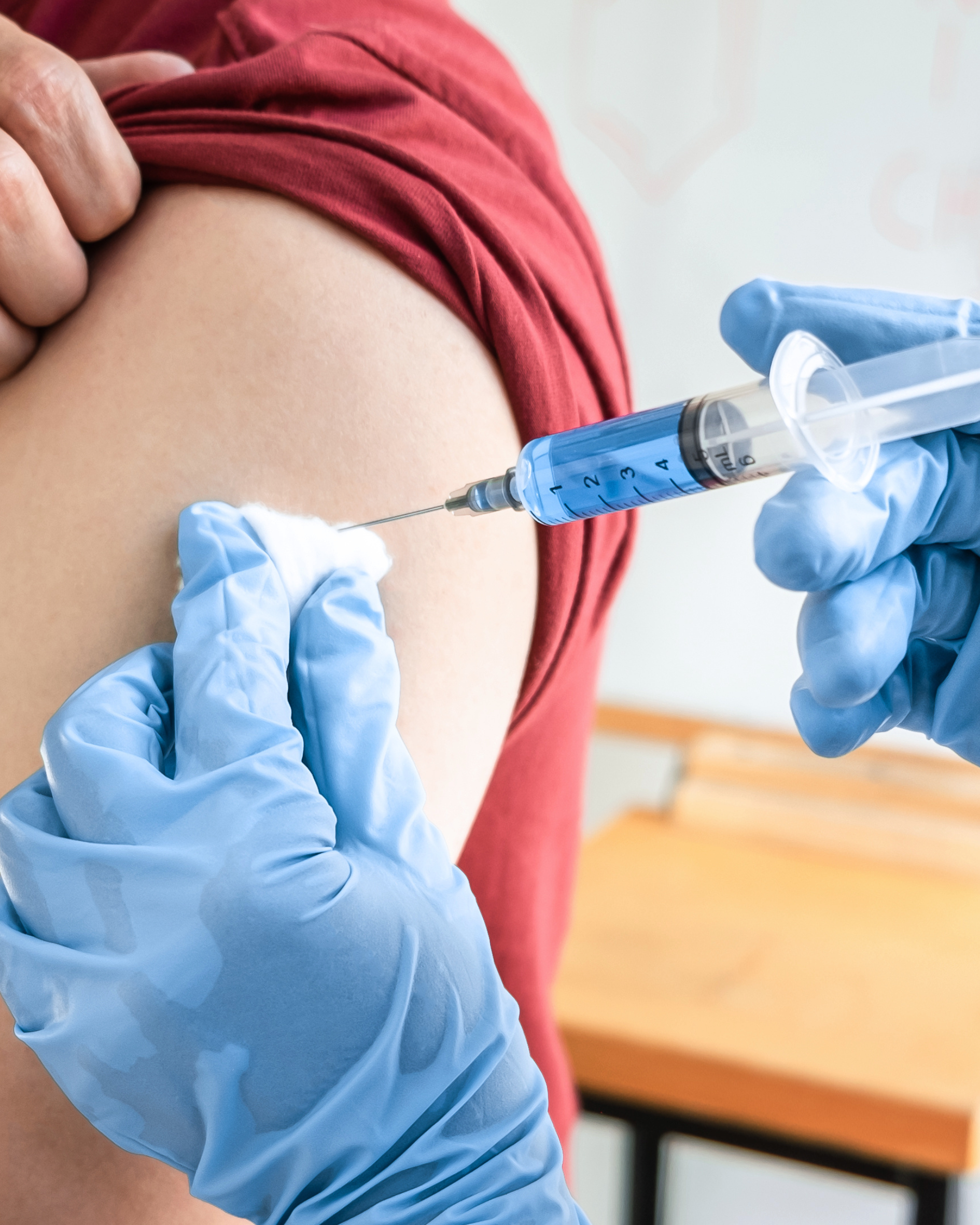 Pharmacist administering shingles vaccine