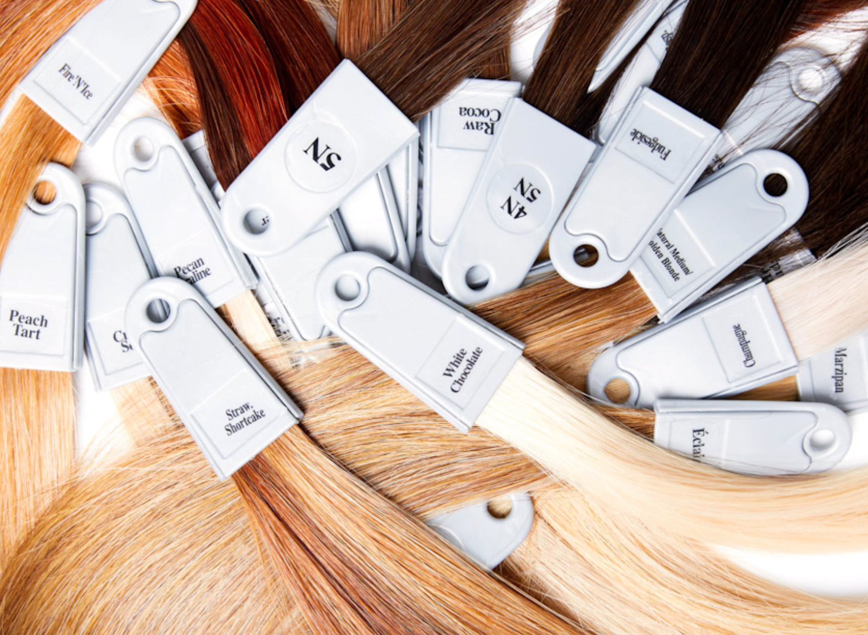 close up image of swatches of hair extension colors swatches of hair extensions color