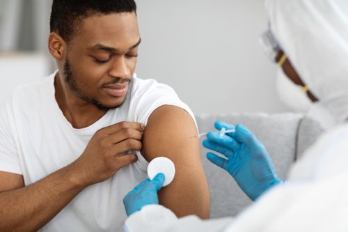 Nurse making COVID-19 vaccine for black guy